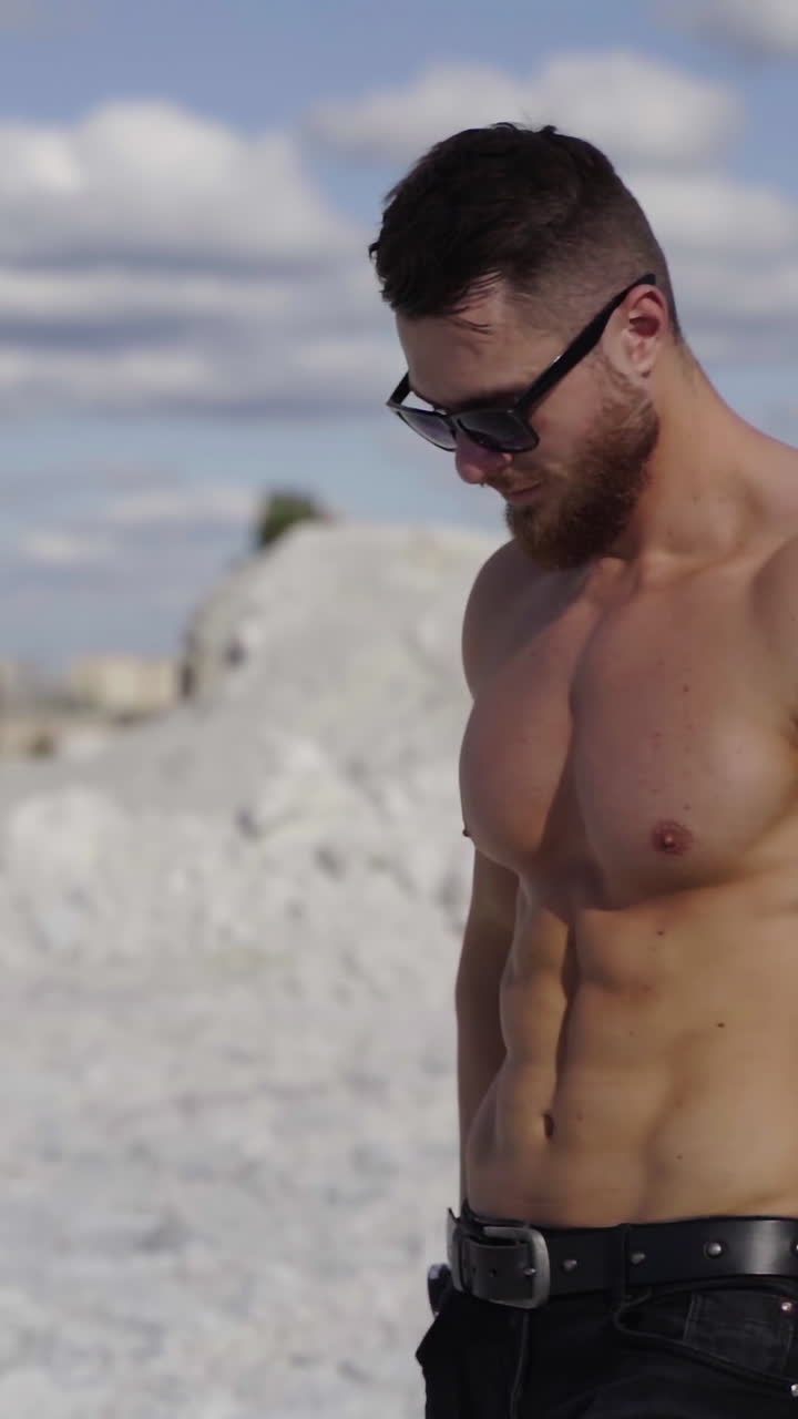 Handsome Muscular Shirtless Man. Handsome young model standing strong outdoors