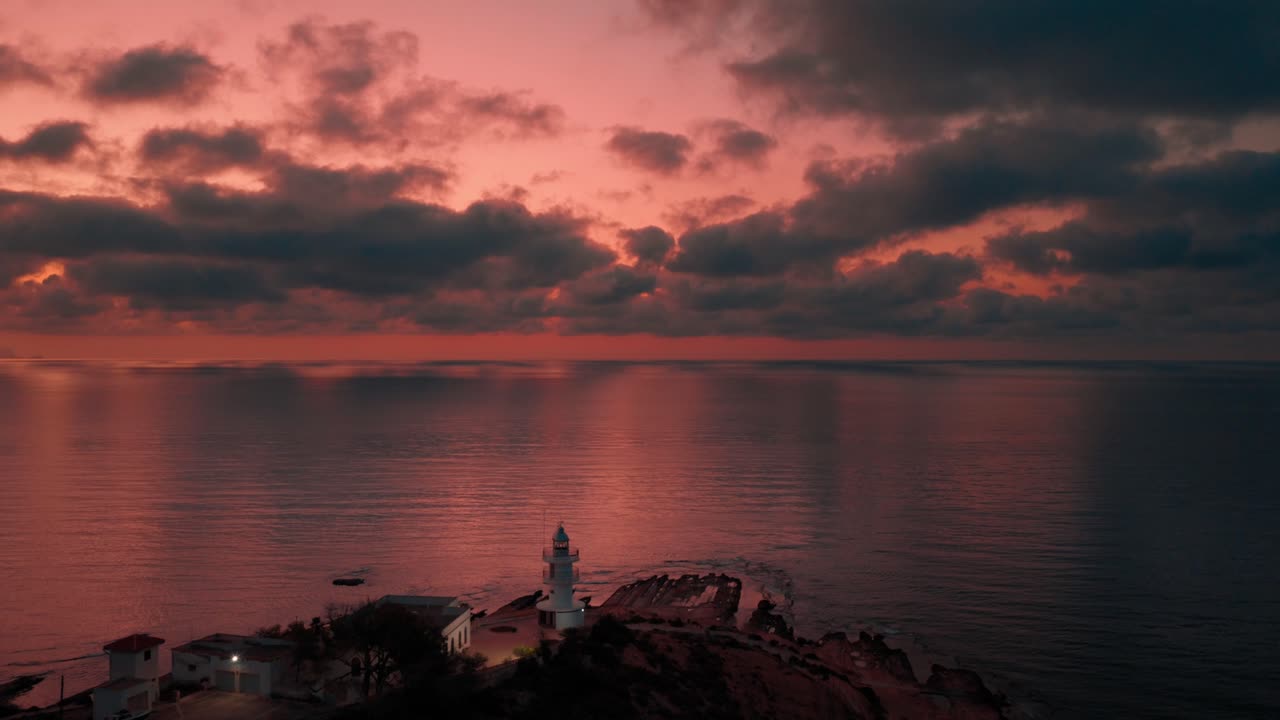 Beautiful lighthouse on the Mediterranean Sea with cloudy sky shot on sunrise on Costa Blanca Spain