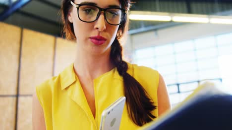 Female-business-executive-looking-at-document