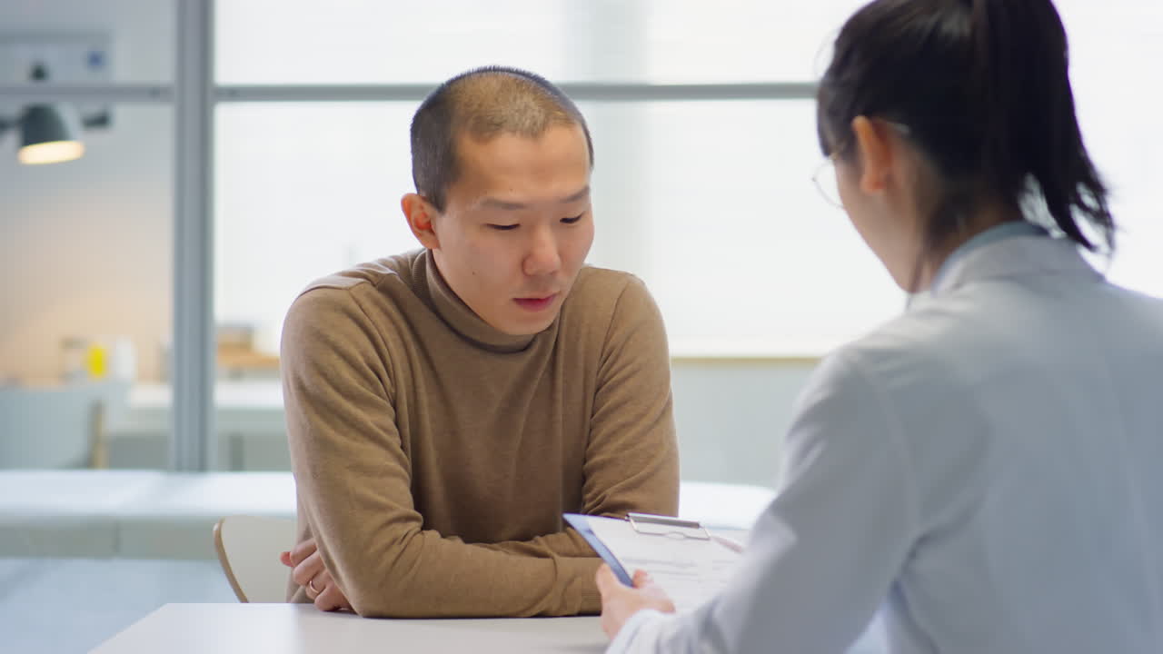 Asian Man Visiting Doctor in Medical Office