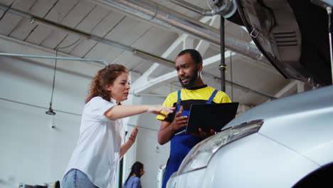 car repairman listens to client request