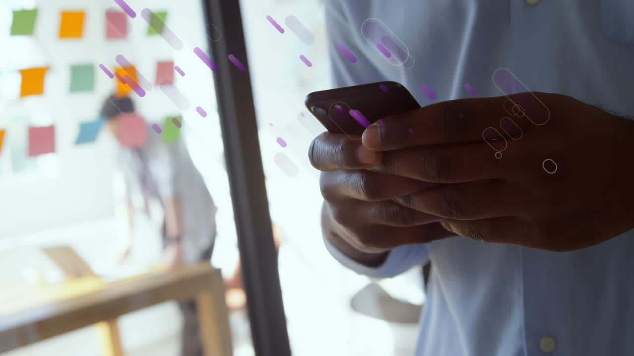 Animation of blue trails over african american businessman using smartphone