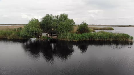 drone footage in danube delta of a traditional isolated fishing house