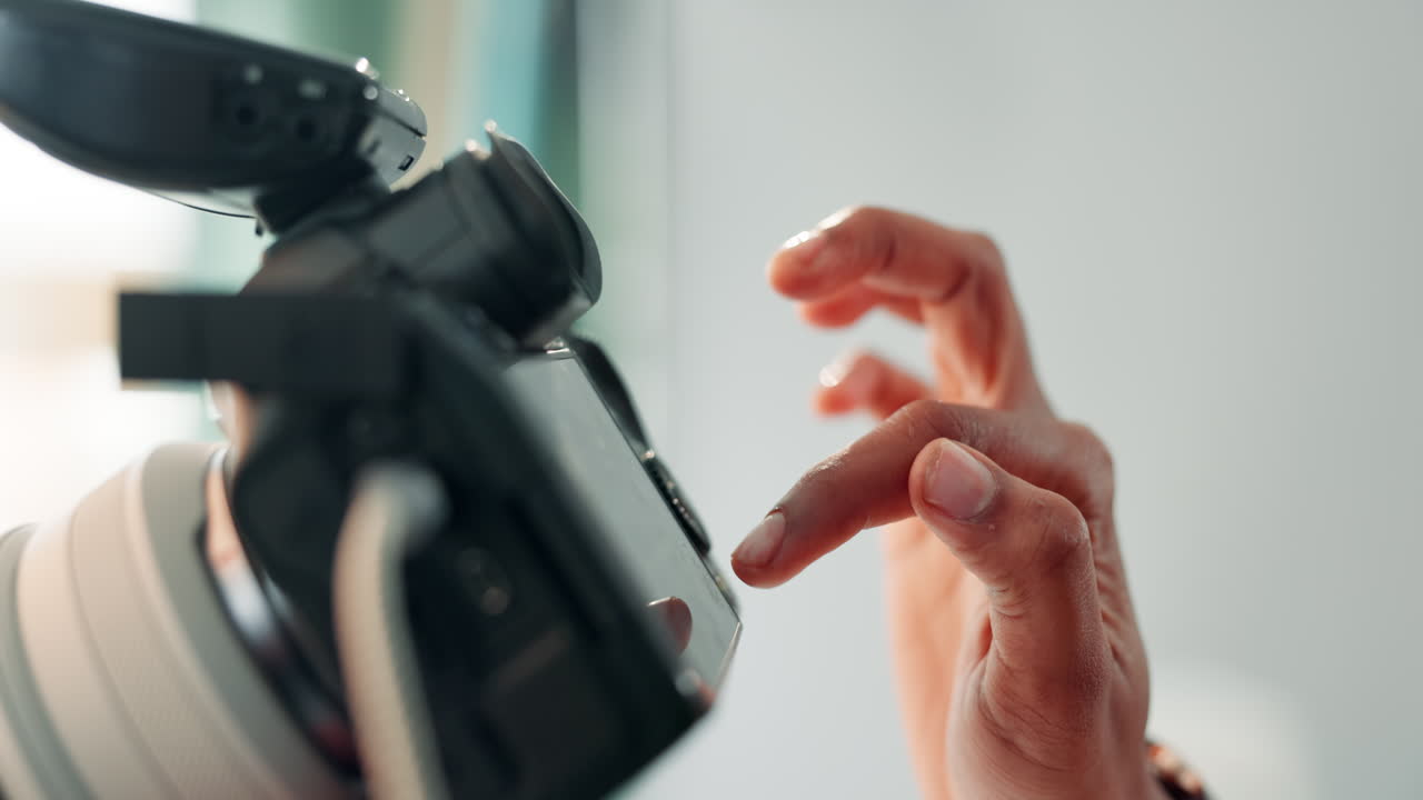 Close-up of a camera and hand