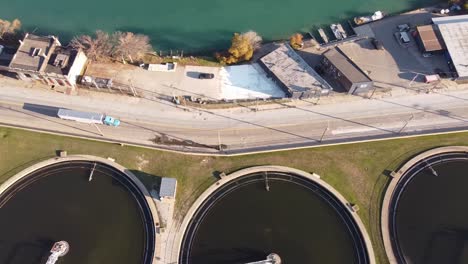 semi-trailer truck driving near the sedimentation tanks of detroit water treatment plant in detroit, michigan