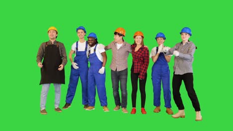 group of male and female engineers and workers raise their hand after achieve their mission or construction on a green screen, chroma key
