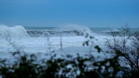 storm waves roll in towards the coast in noja, santander, spain