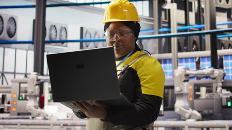 vertical video solar panels plant technician uses laptop to oversee systems