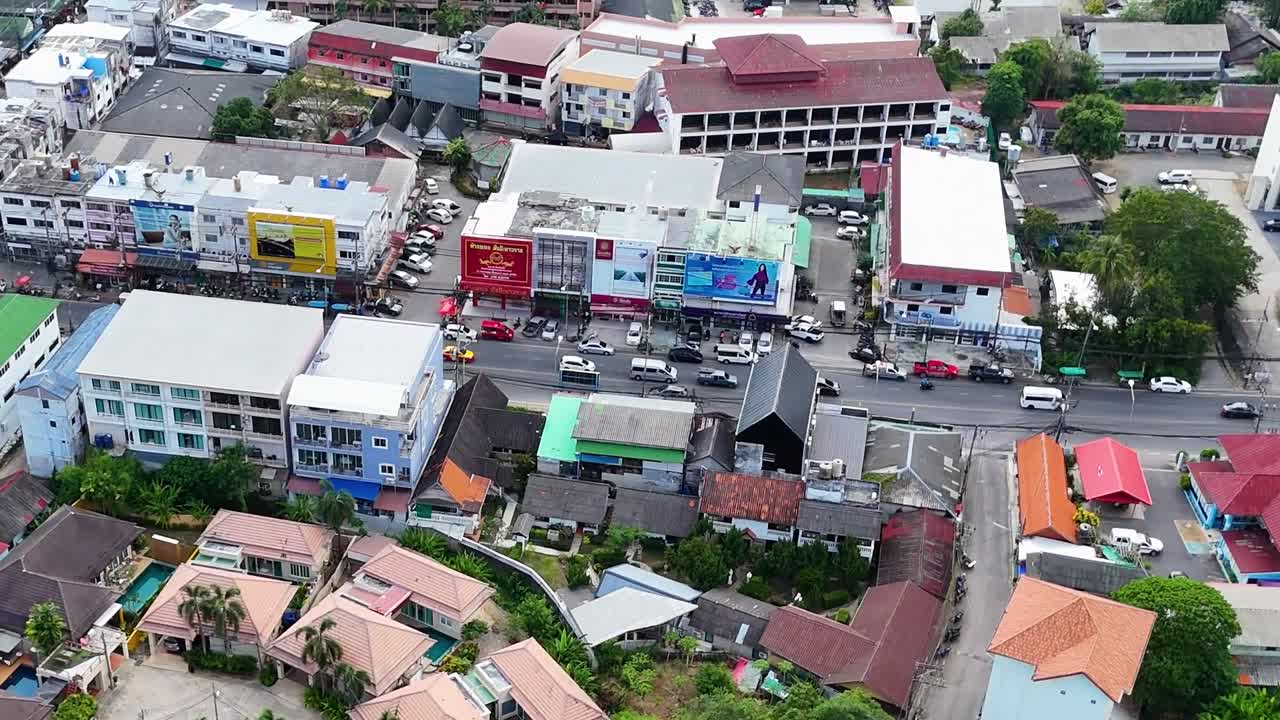 Aerial footage highlights vibrant commercial buildings and bustling streets in Phuket, showcasing urban life and architecture.