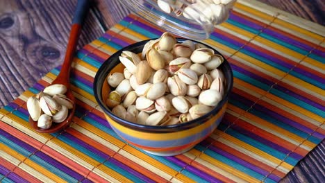 pistachios pouring into a bowl