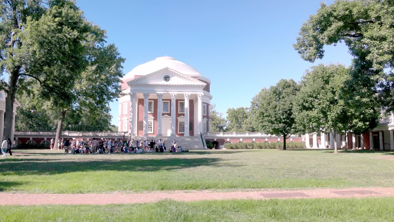 The Rotunda on the campus of the University of Virginia in Charlottesville, Virginia with group of students with video panning left to right.