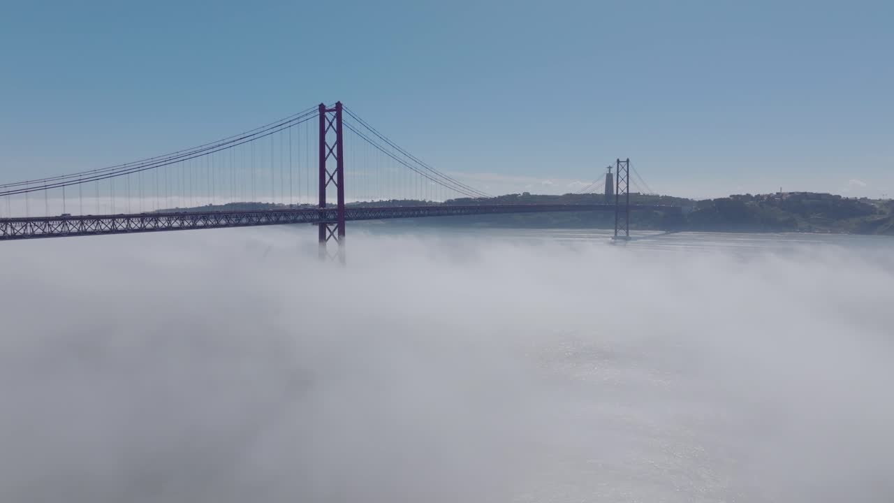 Drone shot of the bridge 25 Abril (Lisbon), in fog.