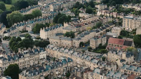 retreating shot revealing circular townhouses and bath cityscape
