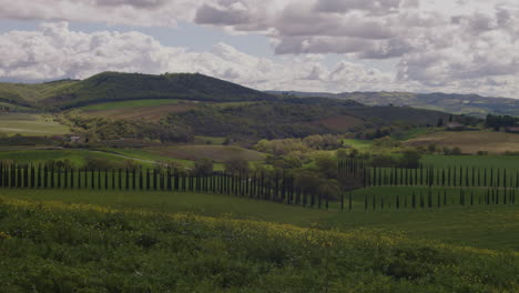 pan across sweeping tuscan italy landscape on beautiful day with cloudy sky