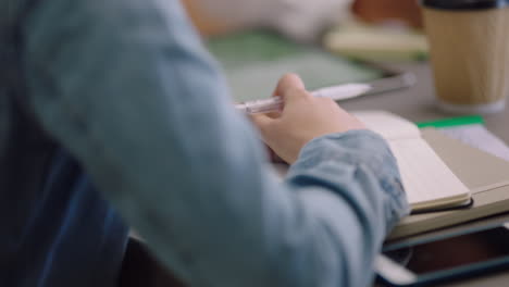 business woman hands writing taking notes in corporate meeting using pen close up