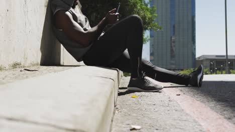 man training in an urban setting taking a break