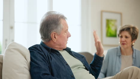 Senior-couple,-argument-and-conflict-on-sofa