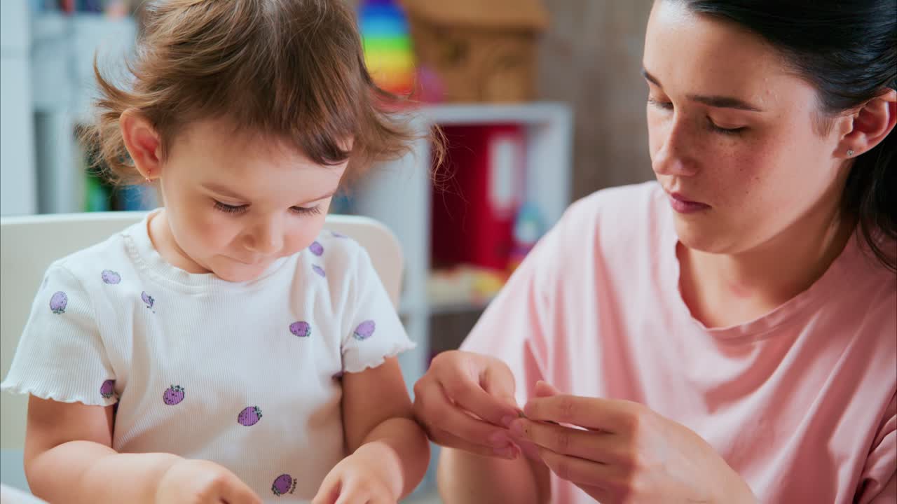 A Heartwarming Moment: A Mother Engages with Her Joyful Toddler in Creative Playtime Activities, Strengthening Their Bond Through Learning and Laughter