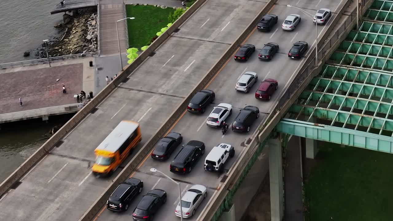 Traffic flows along a busy highway in New York City during the day