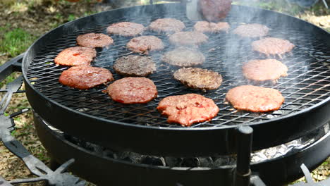 Large-grill-with-many-burgers-being-cooked-on-an-outside