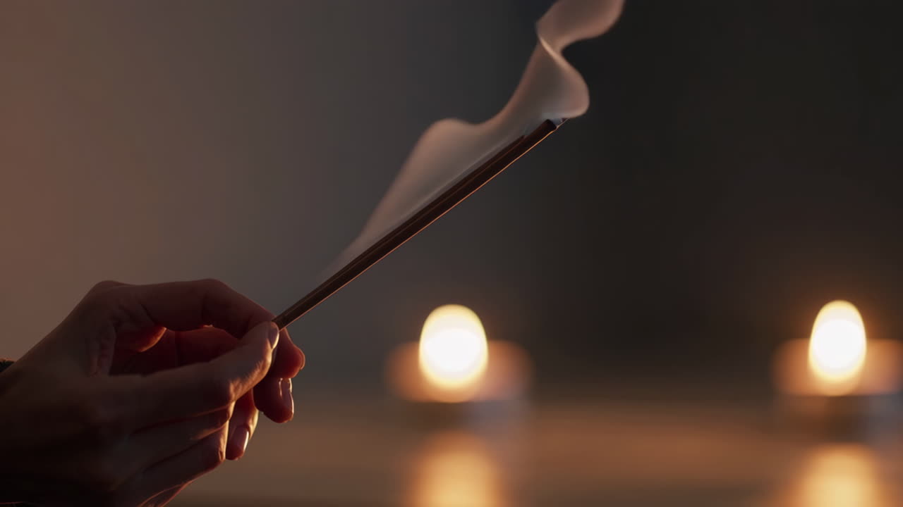 Incense Burning in Hands with Soft Lighting