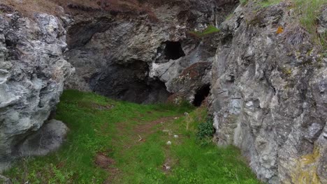 Unique-view-from-a-drone-flying-down-and-into-an-old-magnesium-mine's-entrance