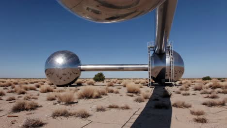 metallic sculpture in a desert landscape