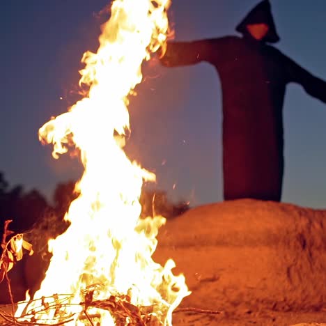 scary figure in black mantle