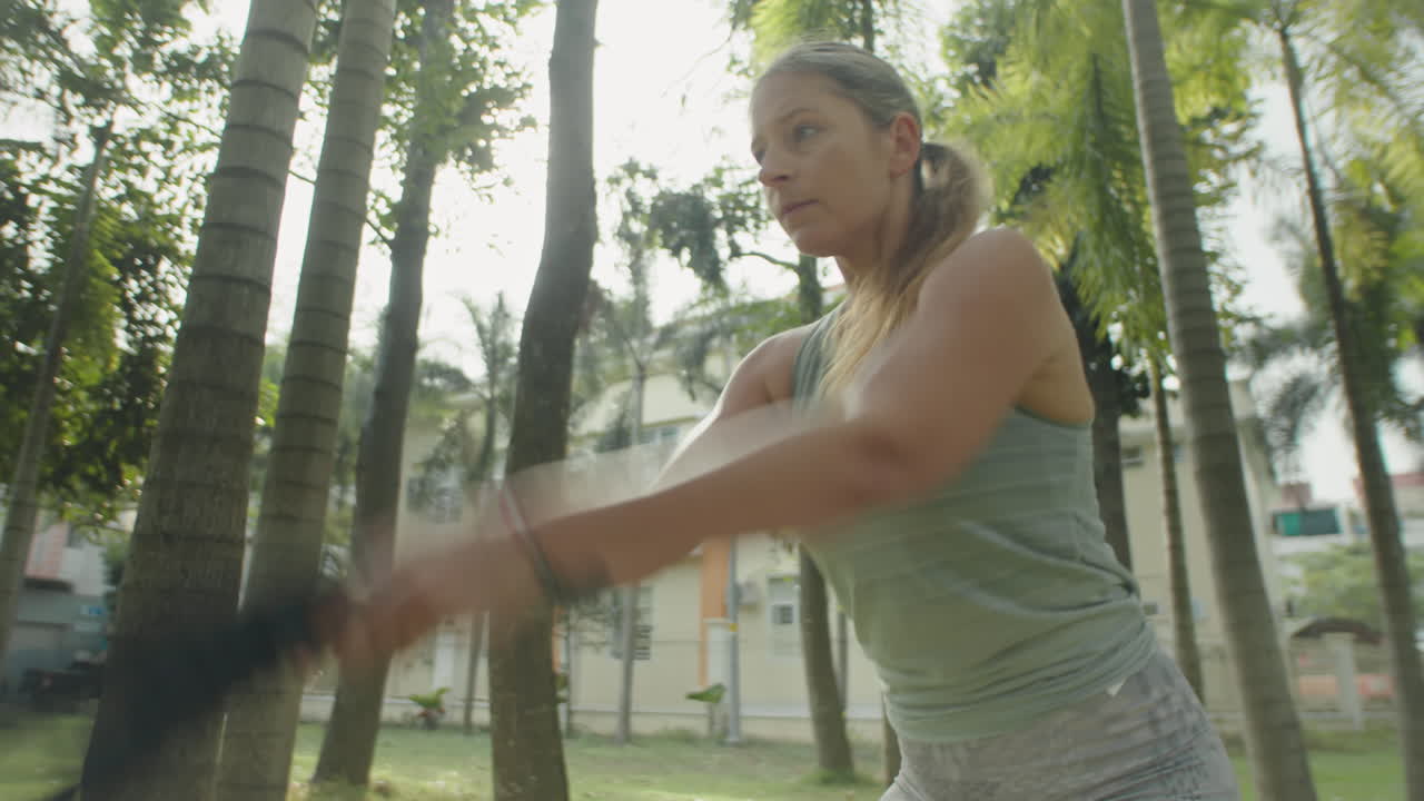 Woman Doing Battle Rope Waves during Workout in Park