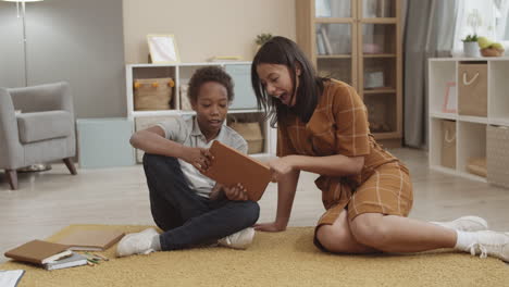 mother and son using tablet together at home