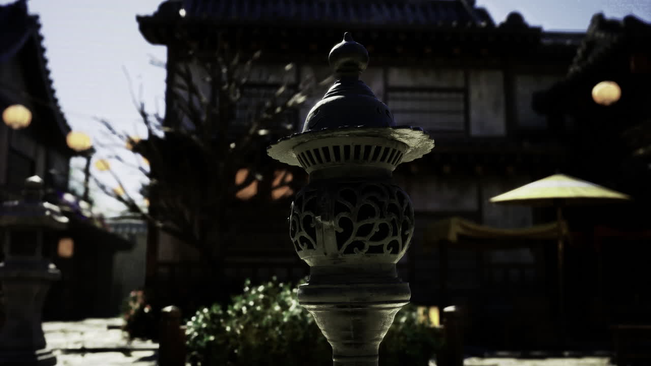 Lanterns illuminate a traditional building in the evening courtyard