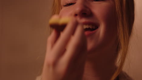 teenage girl eating a cookie