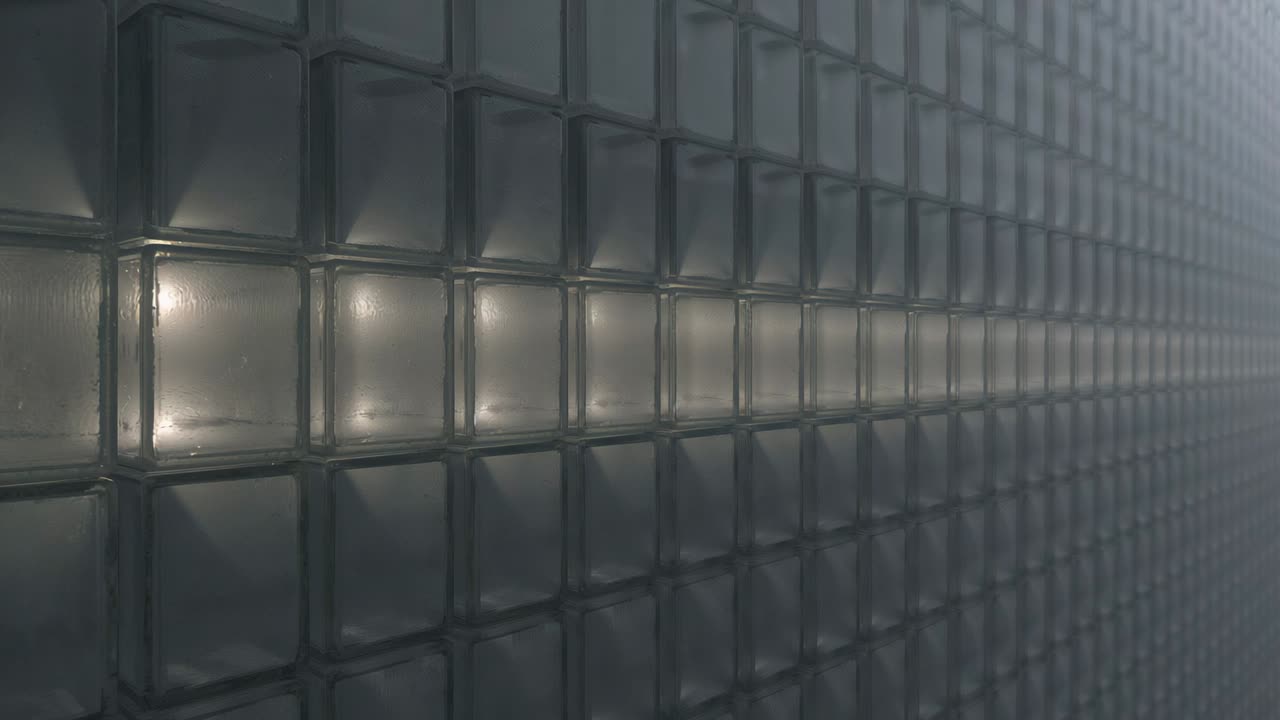 Lighting single module lower-left starting tiles lighting along glass block wall, forming warm band