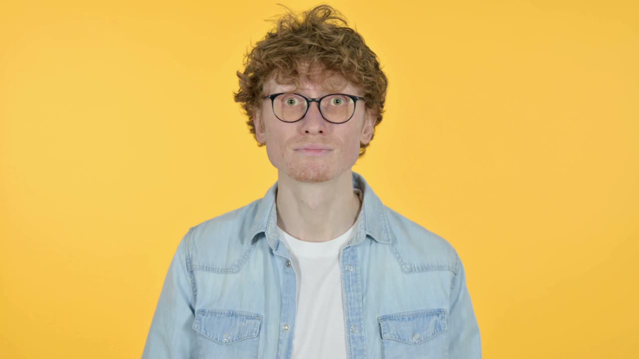Redhead Young Man Yes by Head Shake, Yellow Background