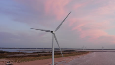 windturbines during sunset on the island neeltje jans, the netherlands