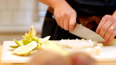 chef chopping kohlrabi into pieces