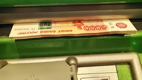 cash withdrawal in ruble banknotes at an ATM.