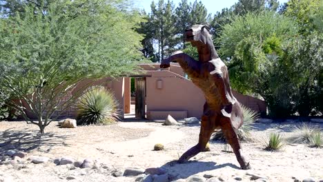 sculpture of a large metal horse on hind legs straight on view