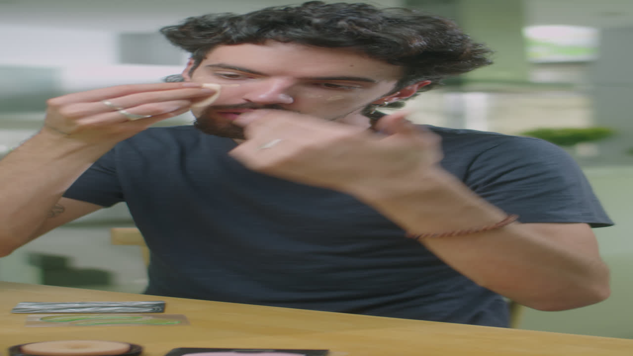 Male Blogger Applying Makeup on Camera