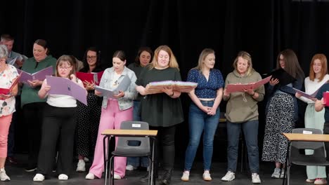 group of local amateur theatre performers rehearsing together on stage
