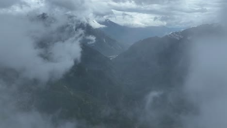 mist-covered mountain valley with clouds and lush greenery in theth region