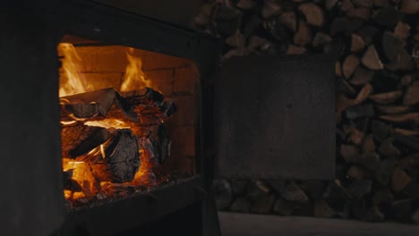 firewood burning in an open wood stove at home