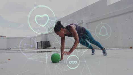 Animation-of-technological-icons-over-woman-exercising-with-a-ball