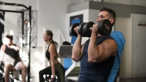 men and women exercising with dumbbells in a gym