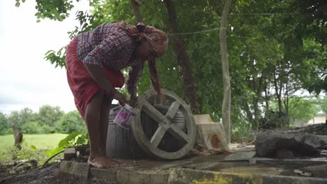 low angle shot of an indian village woman washing her feet after working in the farmland