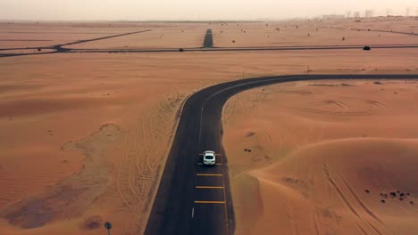 4k drone footage, a road between desert, dubai’s half desert road, geological landscape of high dune desert in the united arab emirates, drone videos