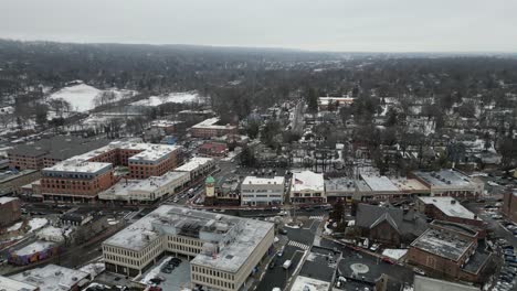 aerial drone footage of south jersey in winter, featuring snow-covered rooftops, streets, and urban areas. capturing the cold season’s atmospher