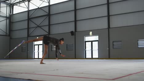 female gymnast performing at sports hall