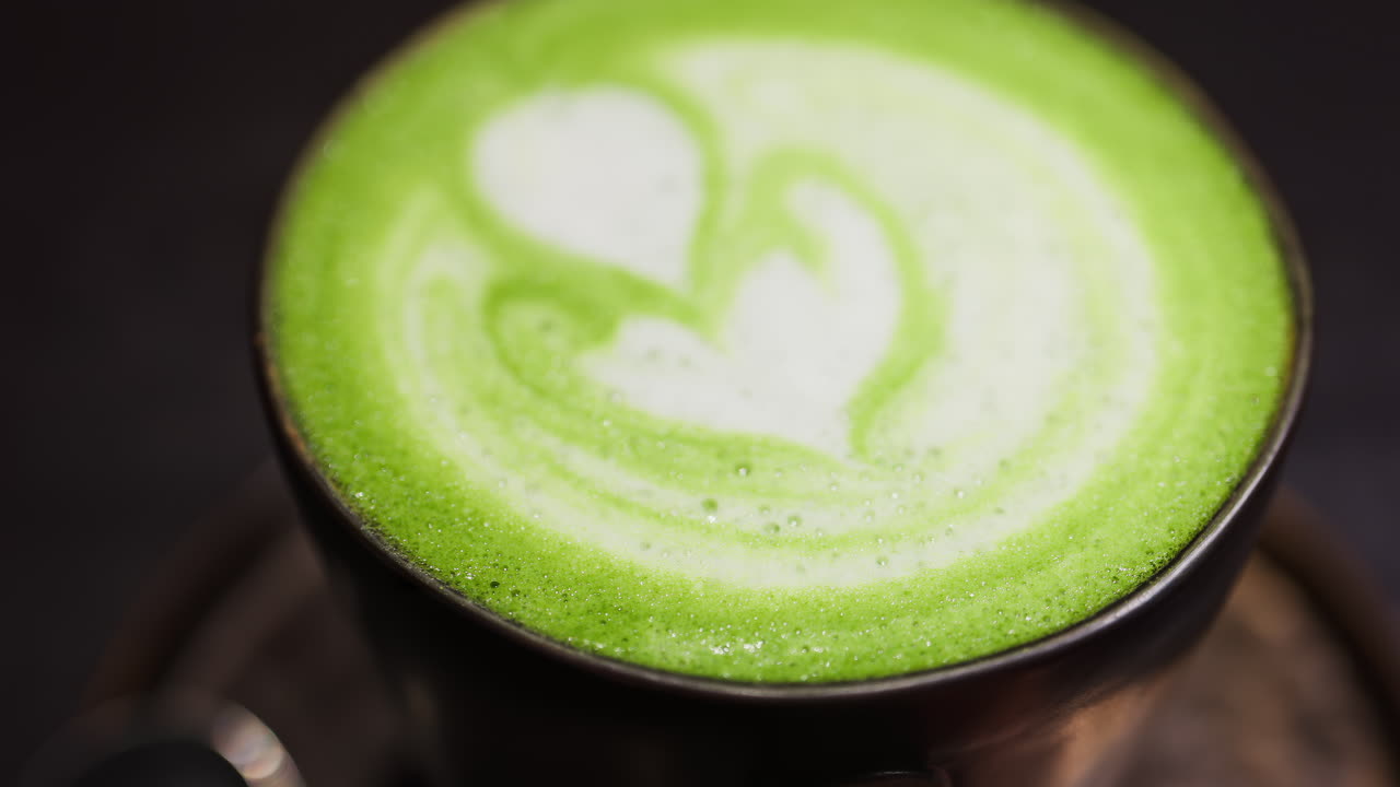 Close up of a matcha latte on a tray at a cafe