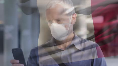 animation of flag of france waving over caucasian man wearing face mask in city street